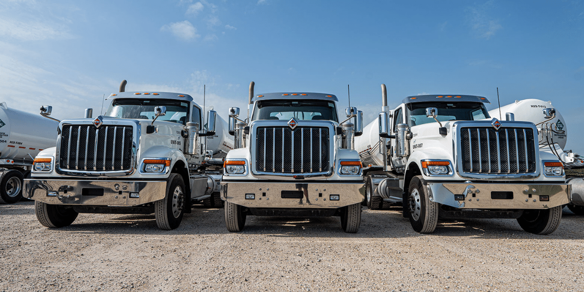 Close up of the front of 3 transport trucks