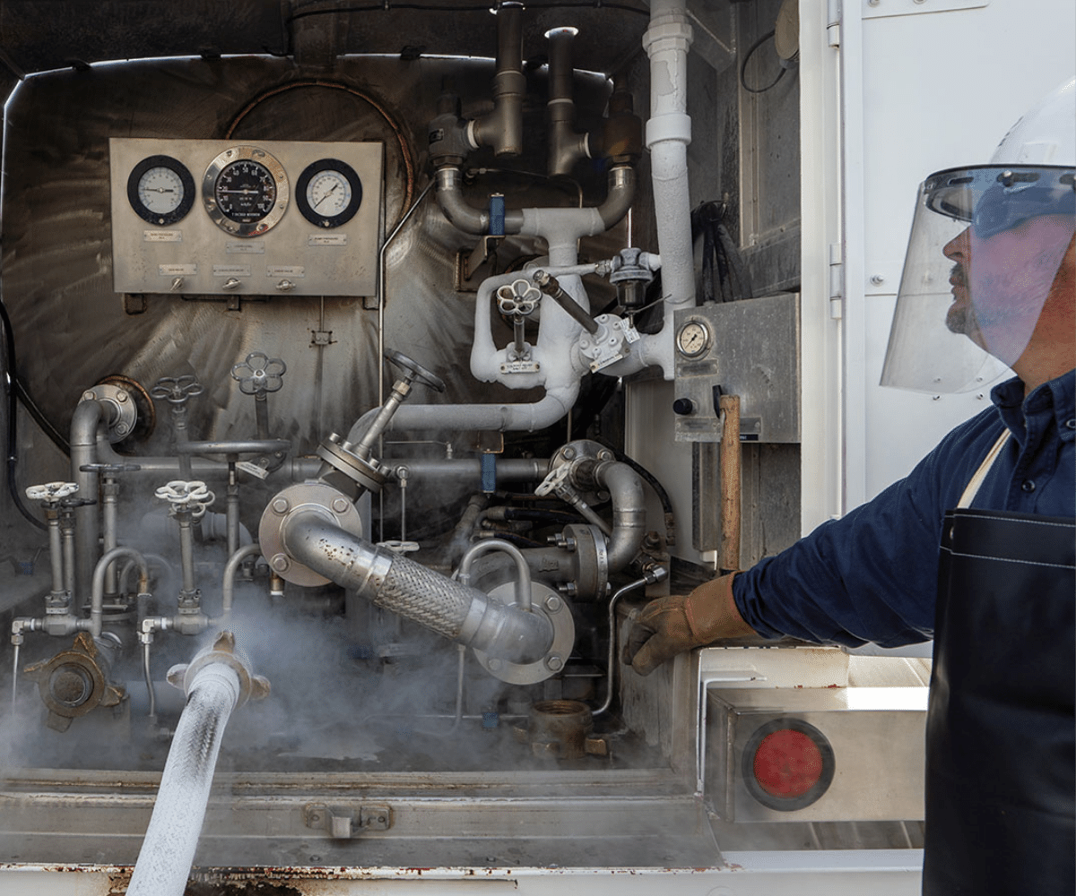 man in hard hat and safety gear working on a nitrogen valve